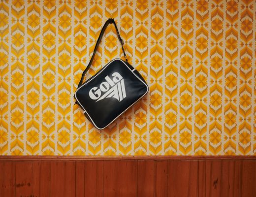 Redford bag hanging on a wall against retro wall paper
